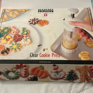 By Kuhn Rikon, clear barrel cookie press with accessories.